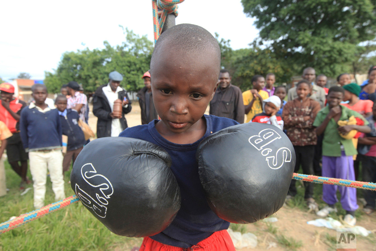 In this Sunday, March 11, 2017 photo a young boy prepares to fight in Chitungwiza, Zimbabwe. (AP Photo/Tsvangirayi Mukwazhi)