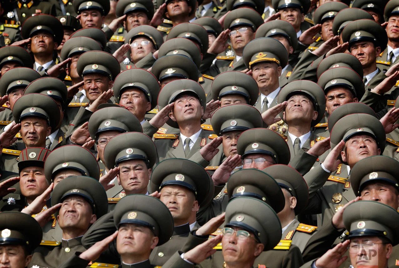 Soldiers salute as the national anthem is played during a military parade to celebrate the 105th birth anniversary of Kim Il Sung, in Pyongyang, North Korea, on Saturday, April 15, 2017. (AP Photo/Wong Maye-E)