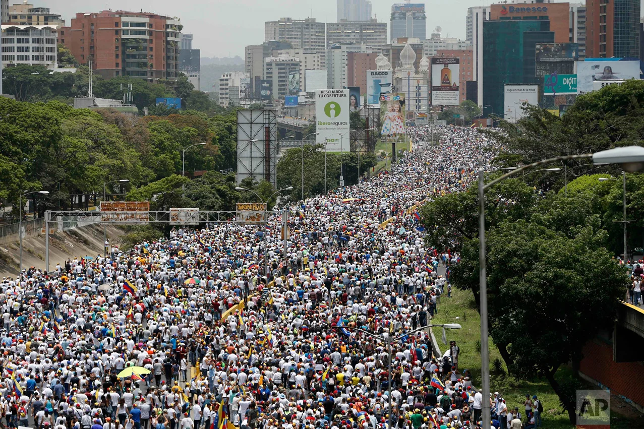 Anti-government protesters march along a highway in Caracas, Venezuela, Wednesday, April 19, 2017. Opponents of President Nicolas Maduro called on Venezuelans to take to the streets to march against the embattled socialist leader. (AP Photo/Ariana Cubillos)