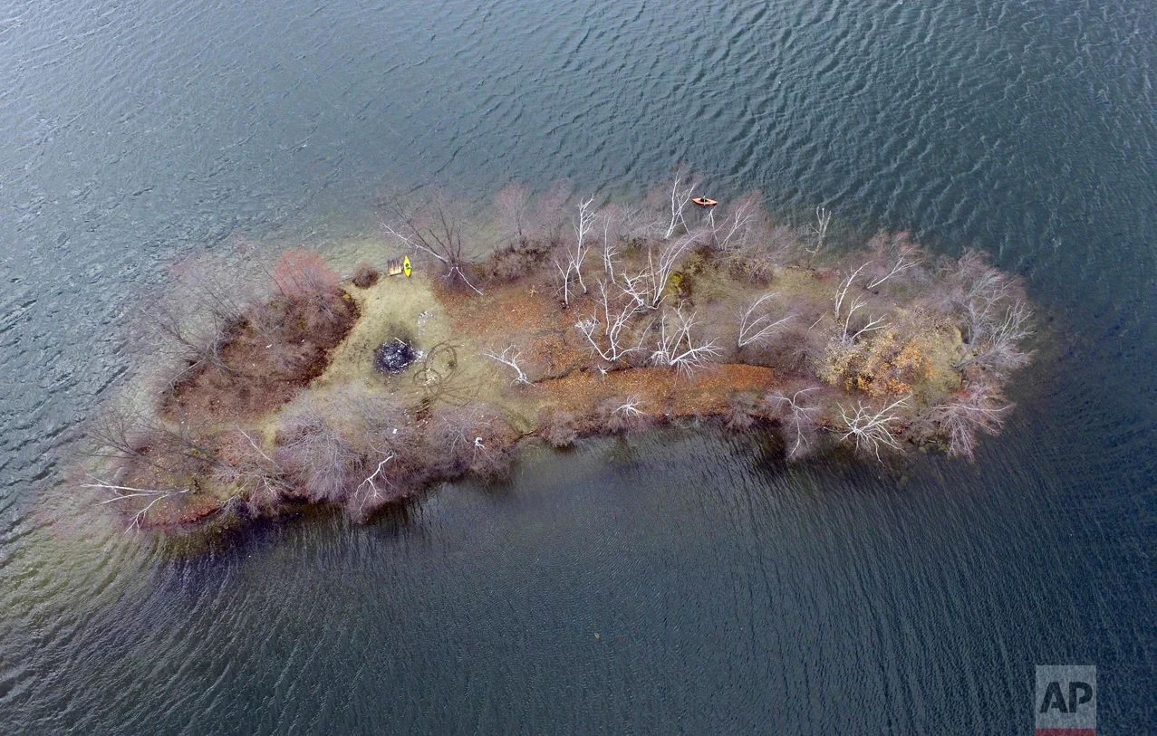 A kayaker circles a small island on Pontoosuc Lake in Pittsfield, Mass., on April 16, 2017. (Ben Garver/The Berkshire Eagle via AP)