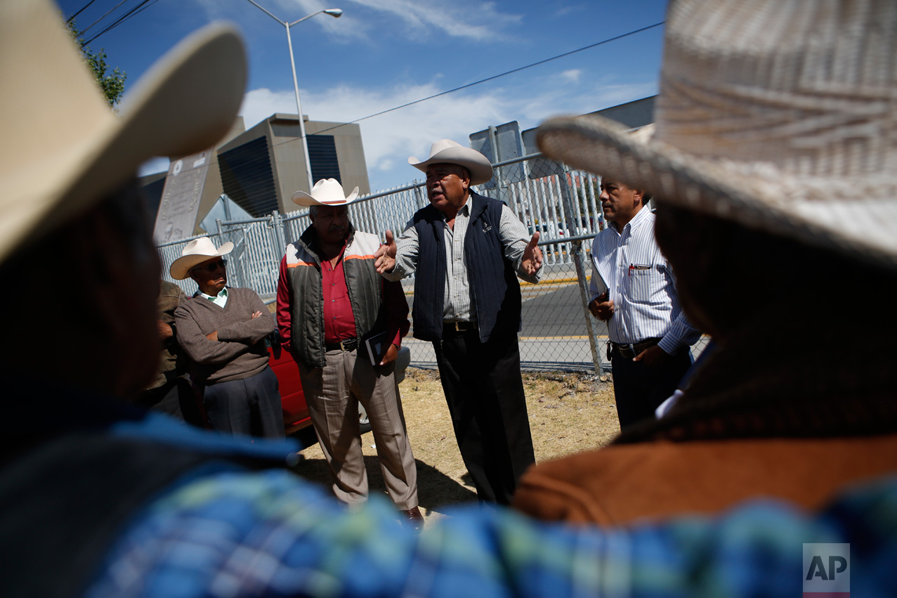 In this Feb. 15, 2017 photo, members of the "Council of Users in Defense of the 'Aguas Negras'" talk with other farmers representing their communities as they prepare for a meeting with elected deputies at the Hidalgo State legislature in Pachuca, Mexico. Farmers have been meeting with elected officials and the National Water Commission to present their concerns. But suspicions run deep, since water has long been a scarce and contentious resource in central Mexico. (AP Photo/Rebecca Blackwell)