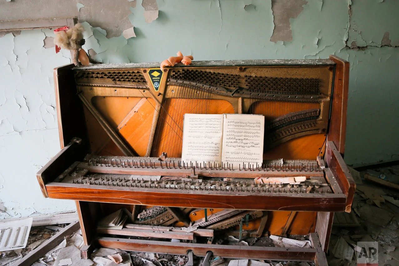 In this photo taken Wednesday, April 5, 2017, a decrepit piano stands in a school in the deserted town of Pripyat, some 3 kilometers (1.86 miles) from the Chernobyl nuclear power plant Ukraine. (AP Photo/Efrem Lukatsky)