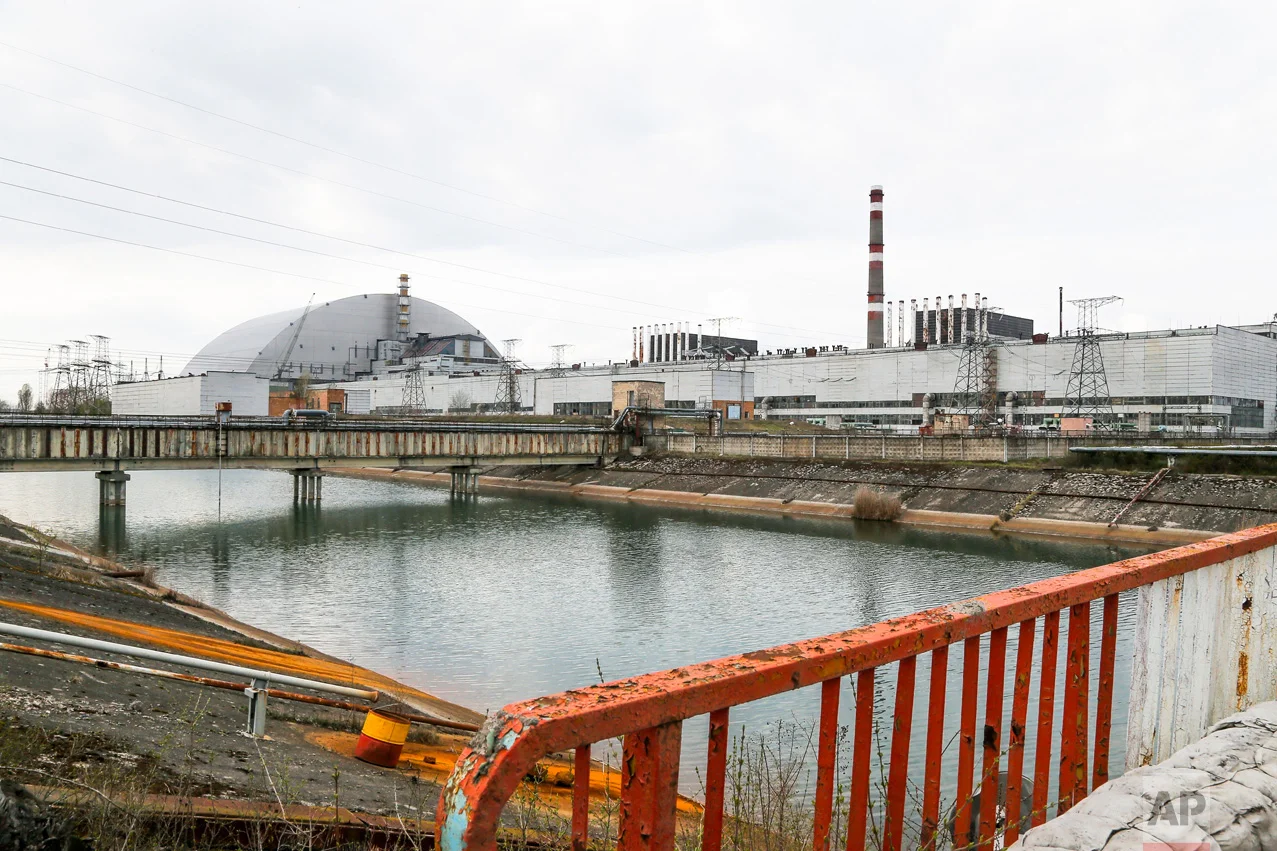 In this photo taken Wednesday, April 5, 2017, a new shelter is installed over the exploded reactor at the Chernobyl nuclear plant, in Chernobyl, Ukraine. (AP Photo/Efrem Lukatsky)