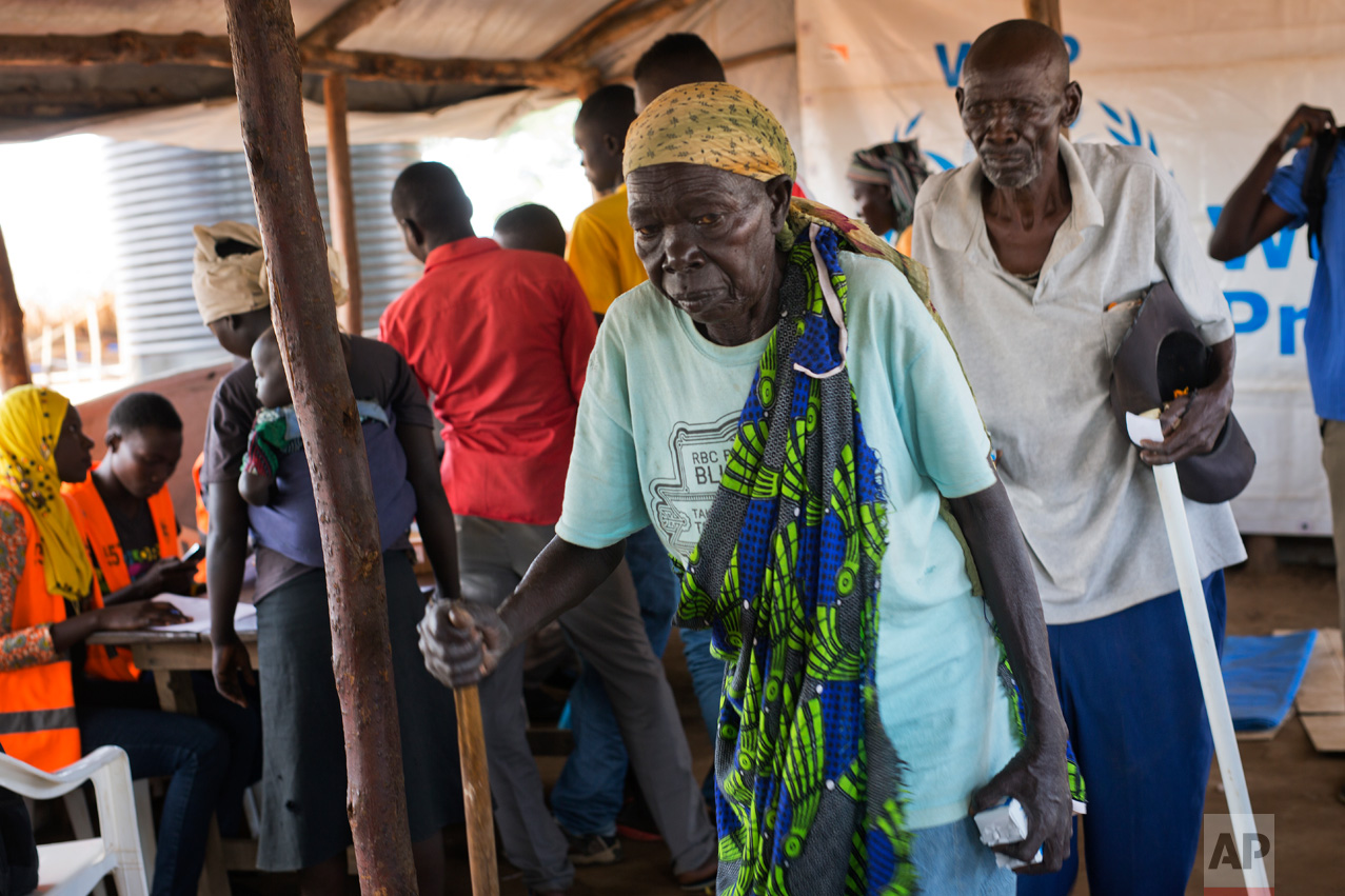 In this Wednesday March 29, 2017 photo, Kassa Wani and her husband, Alfred, from South Sudan, wait to register with U.N. officials as they arrive at the Busia, Uganda processing center. The civil war in South Sudan has killed tens of thousands and driven out more than 1.5 million people in the past three years, creating the world’s largest refugee crisis. (AP Photo/Jerome Delay)