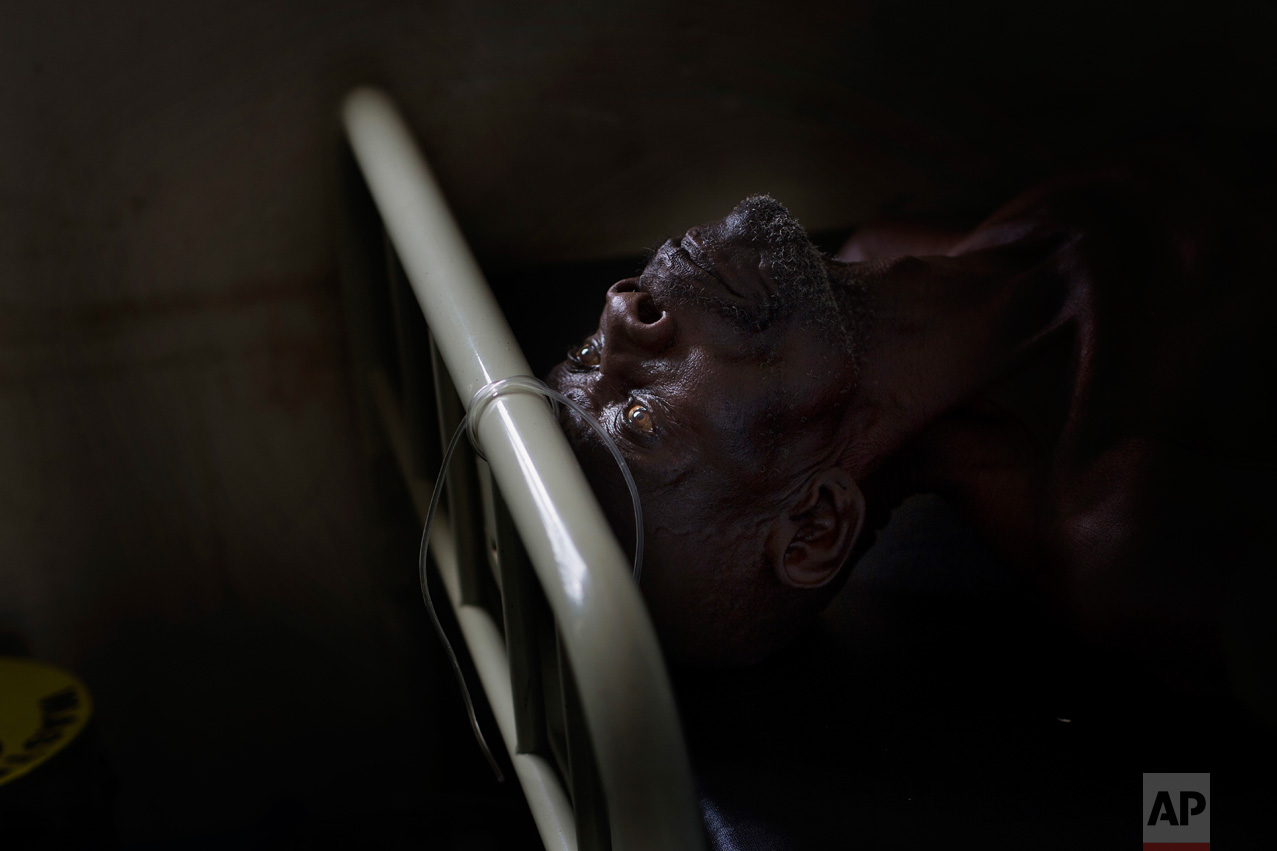 In this Monday, April 3, 2017 photo, Alfred Wani lays on a bed in the clinic at the Imvepi refugee settlement in northern Uganda. Alfred fell ill during the night and had to have blood drawn. (AP Photo/Jerome Delay)