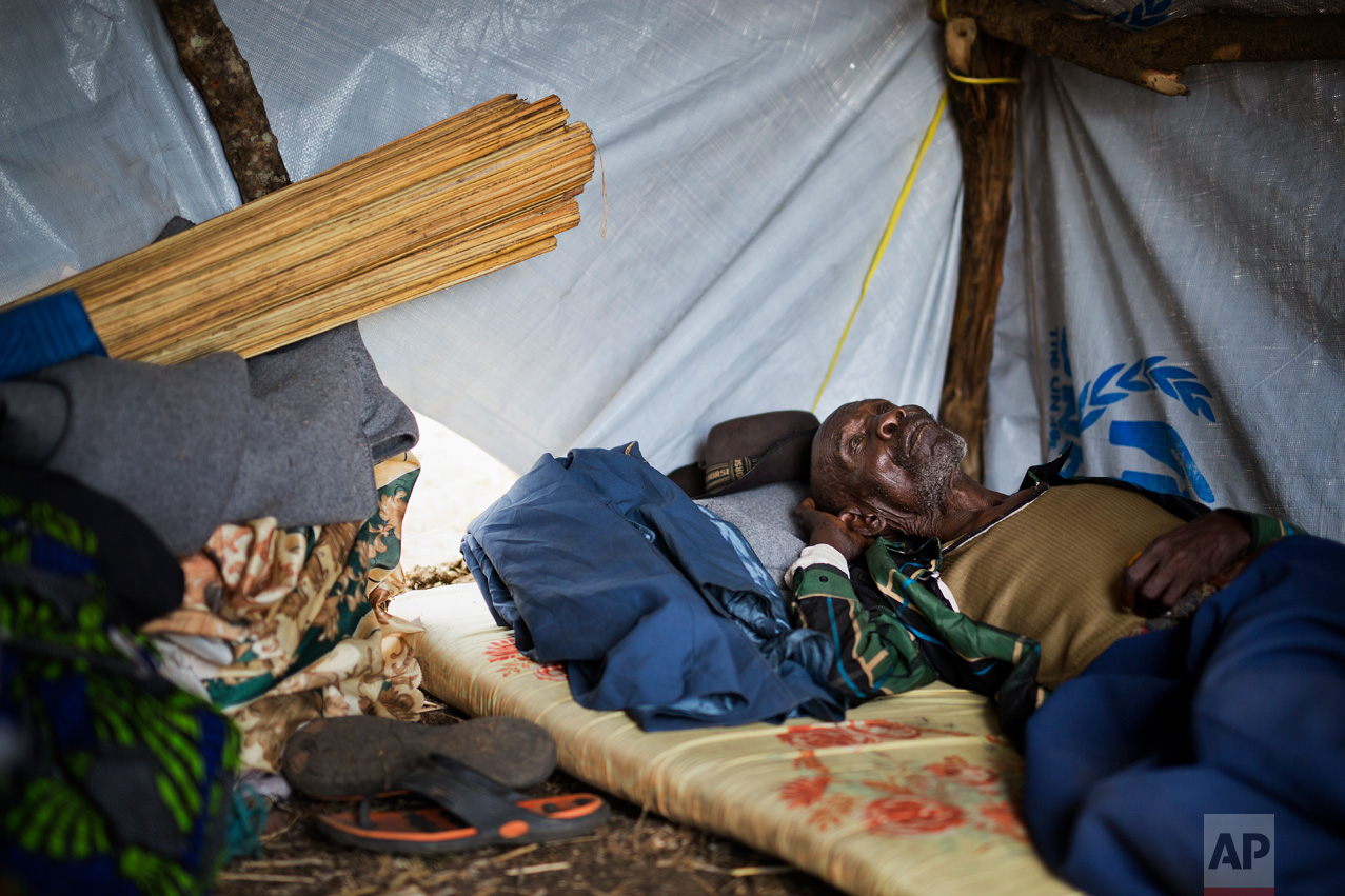 In this Thursday, April 6, 2017 photo in the Imvepi camp, Alfred Wani rests in the just built temporary shelter that will be called home on the plot of land he and family were allocated by the Ugandan government for their resettlement. Wani, a farmer, shares a few regrets: “If I was young again, I would raise more cattle, and build a good house in concrete, and also pay for my kids’ school. I didn’t go to school and neither did my children.” (AP Photo/Jerome Delay)