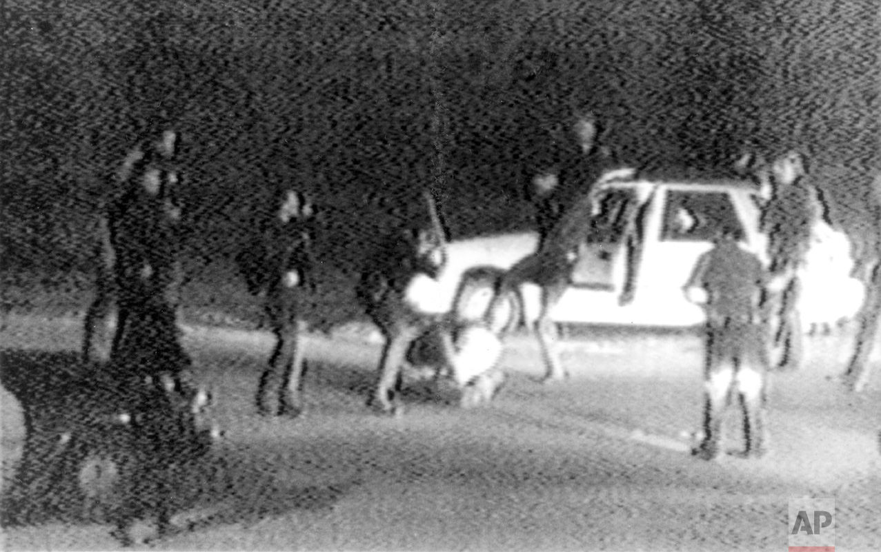 This March 3, 1991 image made from video provided by KTLA Los Angeles shows police officers beating Rodney King. King was pulled over by California Highway Patrol officers for speeding on a Los Angeles freeway. King, who later admitted he tried to elude authorities because he had been drinking and was on probation for a robbery conviction, pulled off the freeway and eventually stopped his car in front of a San Fernando Valley apartment building. At that point, Los Angeles police officers took charge of the traffic stop. George Holliday, who lived in the apartment building and was awakened by the noise, came out to videotape the scene. After Holliday turned the video over to a local TV station, it quickly spread and created an international outrage. (George Holliday/KTLA Los Angeles via AP)