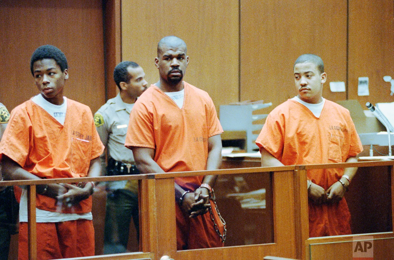 Antoine Miller, Henry Watson and Damian Williams, left to right, stand in Superior Court in Los Angeles, Aug. 25, 1992 for arraignment on charges in connection with the riot-related beating of trucker Reginald Denny. The case was assigned to a black judge who was immediately removed by the prosecution, raising defense claims of racism. (AP Photo/Nick Ut)