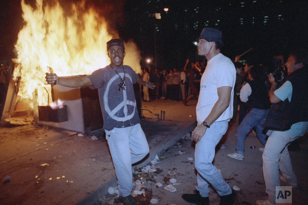Demonstrators protest the verdict in the Rodney King beating case in front of the Los Angeles Police Department headquarters Wednesday, April 29, 1992 in Los Angeles. (AP Photo/Nick Ut)