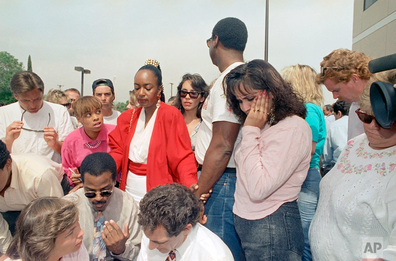 Patricia Moore, second from left, J.D. Rosborough, second from right and Sandy Martinez, right, react with anger and tears at the acquittal of four Los Angeles police officers in the Rodney King assault case in Simi Valley, California on Wednesday, April 30, 1992. All officers were found not guilty with the exception of one charge against Laurence Powell in which the jury was undecided. (AP Photo/Nick Ut)