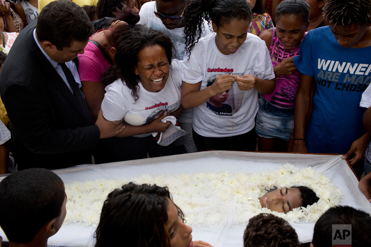 Michele de Oliveira, mother of Paulo Henrique Oliveira, a 13-year-old who local media says was killed by a stray bullet during a shootout between police and criminals, cries during his burial in Rio de Janeiro, Brazil, Wednesday, April 26, 2017. (AP Photo/Silvia Izquierdo)