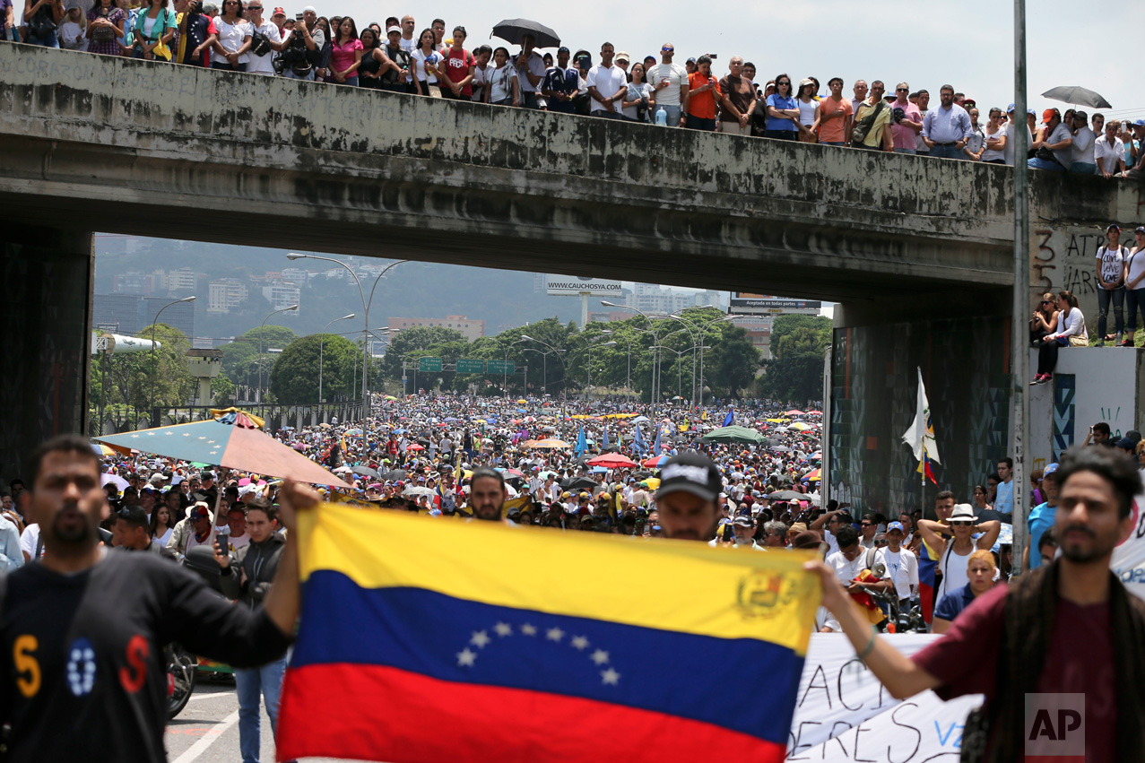 In this Monday, April 24, 2017 photo, anti-government protesters block a highway in Caracas, Venezuela. President Nicolas Maduro has repeatedly called for renewed talks between the two sides, but opposition leaders have discarded that as an option after earlier talks collapsed in December. (AP Photo/Fernando Llano)