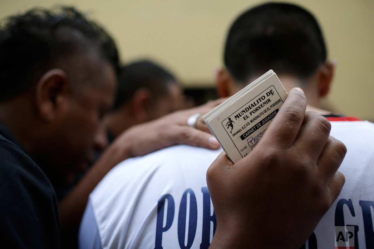  In this Monday, May 1, 2017 photo, the soccer team "Porvenir Unidad" prays before their game at the Little World Cup Porvenir street soccer championship in the Porvenir neighborhood of Lima, Peru. The annual May ritual saw 30 games played in the are