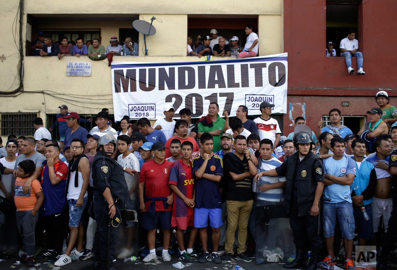  In this Monday, May 1, 2017, police are interspersed among fans on the sidelines of the final Little World Cup Porvenir street soccer final  championship game in Lima, Peru. All 56 teams bring their fans to defend each goal, even if it comes to blow