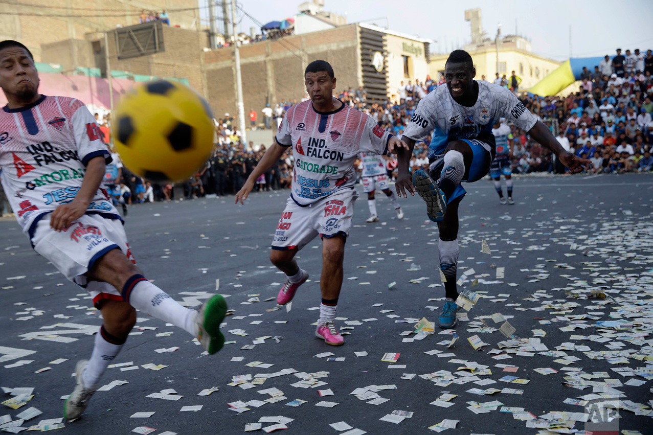  In this Monday, May 1, 2017 photo, teams "Purito Barrios Altos" and "Ají San Cosme" play the final game at the Little World Cup of Provenir street soccer championship in Lima, Peru. The tournament has been a big focus for Peruvian fans for a while, 