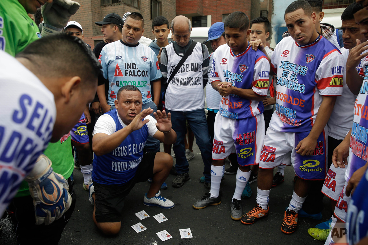  In this Monday, May 1, 2017 photo, coach Nestor Paredes huddles with his players before their semi-final game at the Little World Cup Porvenir street soccer championship in Lima, Peru. The wining team takes home this year’s trophy, a $2,500 cash pri
