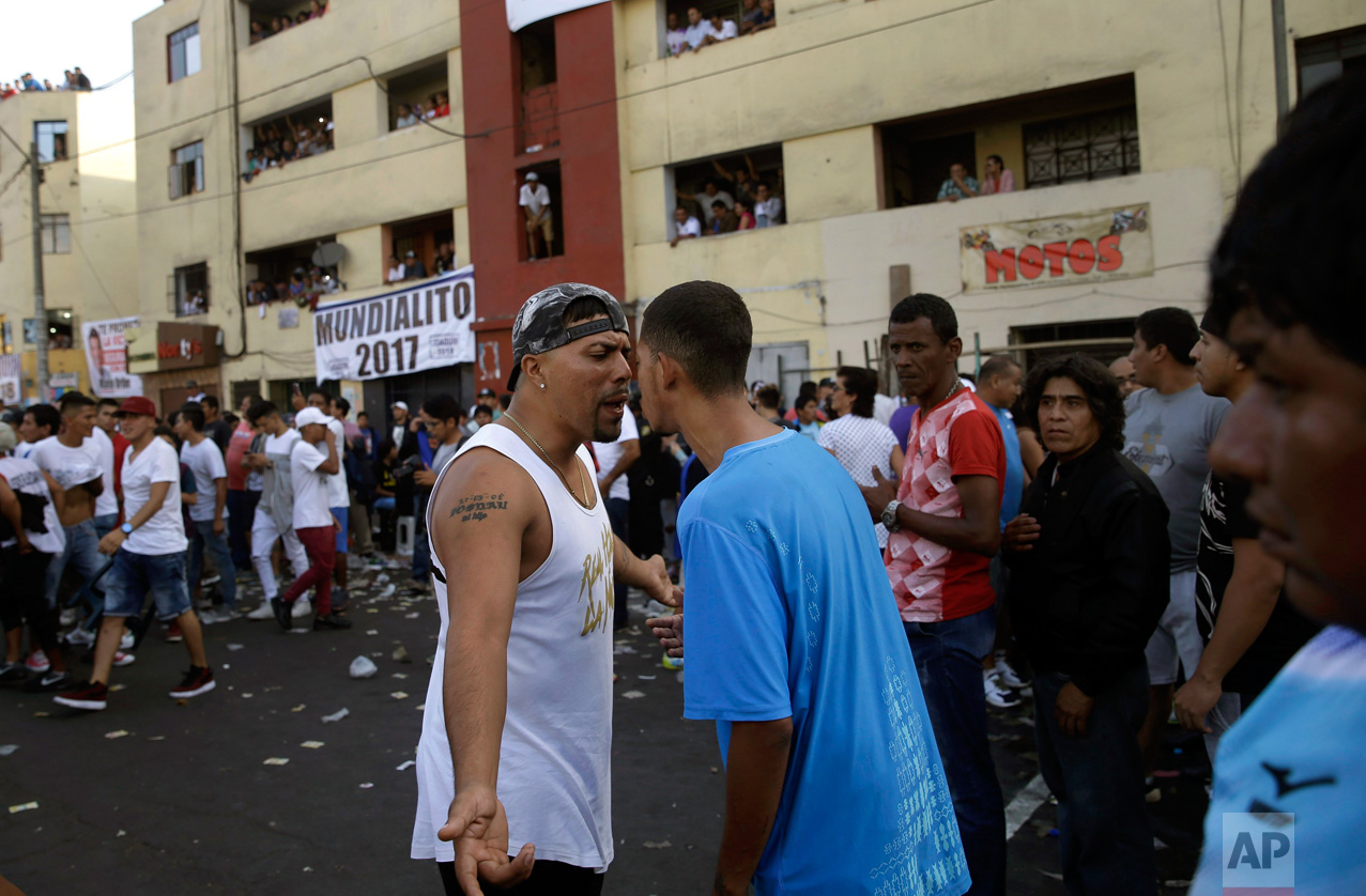  In this Monday, May 1, 2017 photo, fans of rival soccer teams argue at the end of the final game of Little World Cup of Provenir street soccer championship in Lima, Peru. The working-class neighborhood ritual in El Porvenir began in the 1950s as a c