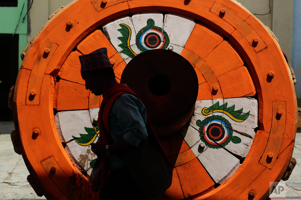  In this April 17, 2017 photo, a Hindu priest performs rituals in front of a wheel that will be part of the Rato Machindranath Chariot in Lalitpur, Nepal. The legend says that around the 7th century there was massive drought in the Kathmandu valley. 