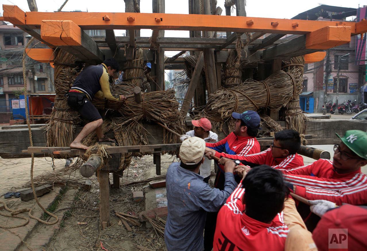 In this April 19, 2017, photo, members of the Yanwal community tie bundles of cane together in the construction of the Rato Machindranath Chariot in Lalitpur, Nepal. The wooden chariot is built to appease the gods in hopes of being blessed with good