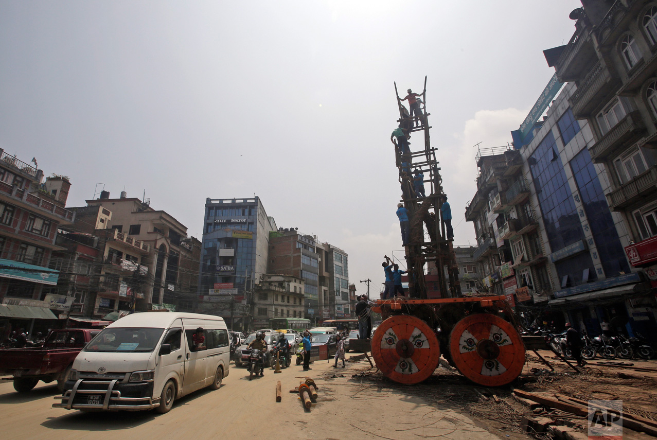  In this April 21, 2017, photo, members of the Barahi community construct the 15-meter (48-foot) tall Rato Machindranath Chariot in Lalitpur, Nepal. The wooden chariot is built to appease the gods in hopes of being blessed with a good rainfall follow