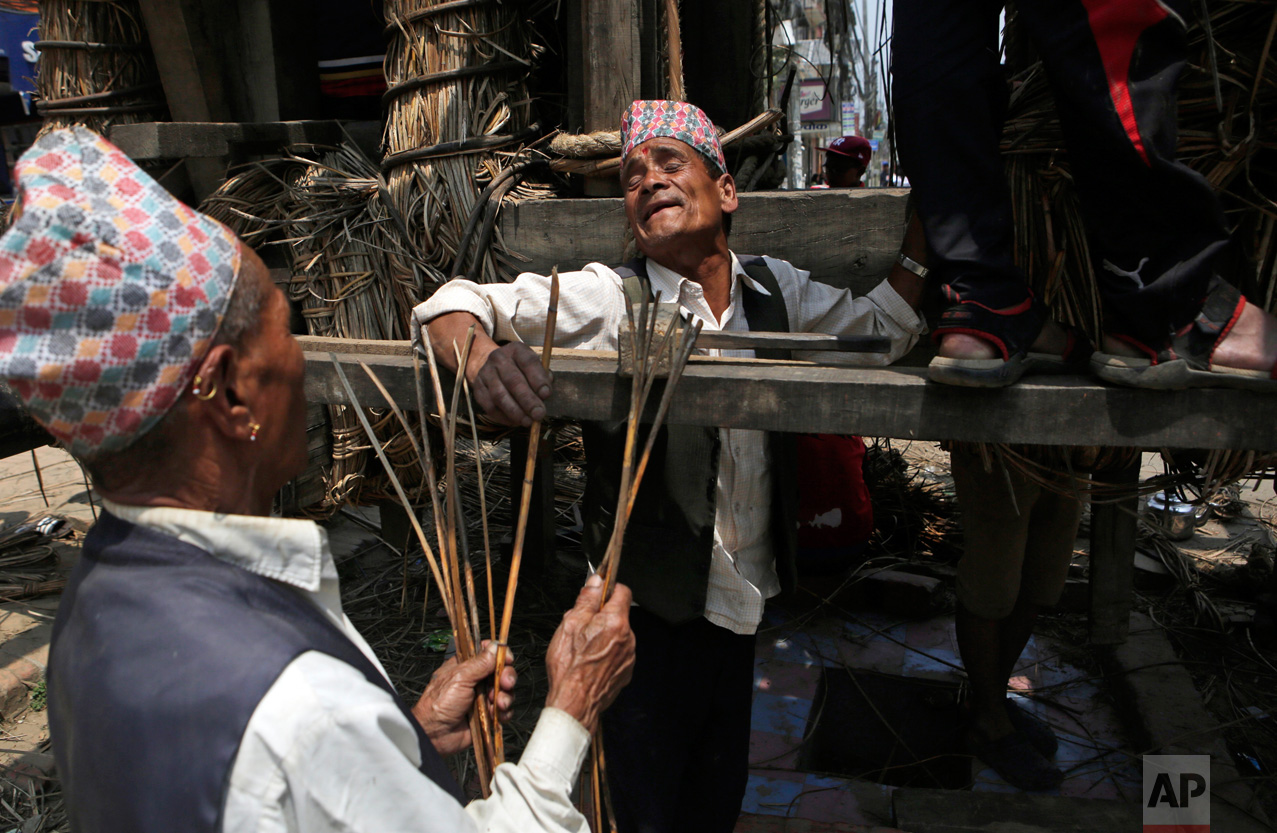  In this April 18, 2017, photo, members of the Yanwal community use strips of cane to construct the Rato Machindranath Chariot in Lalitpur, Nepal. The wooden chariot is built to appease the gods in hopes of being blessed with a good rainfall followed
