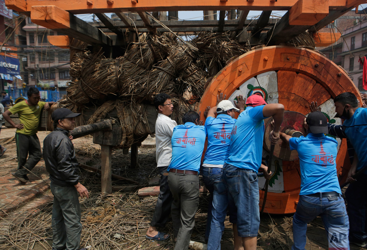  In this April 21, 2017 photo, members of the Barahi community assemble the Rato Machindranath Chariot in Lalitpur, Nepal. The Barahis are responsible for repairing the giant wheels, carving the base and erecting the tower of logs for the chariot. Th