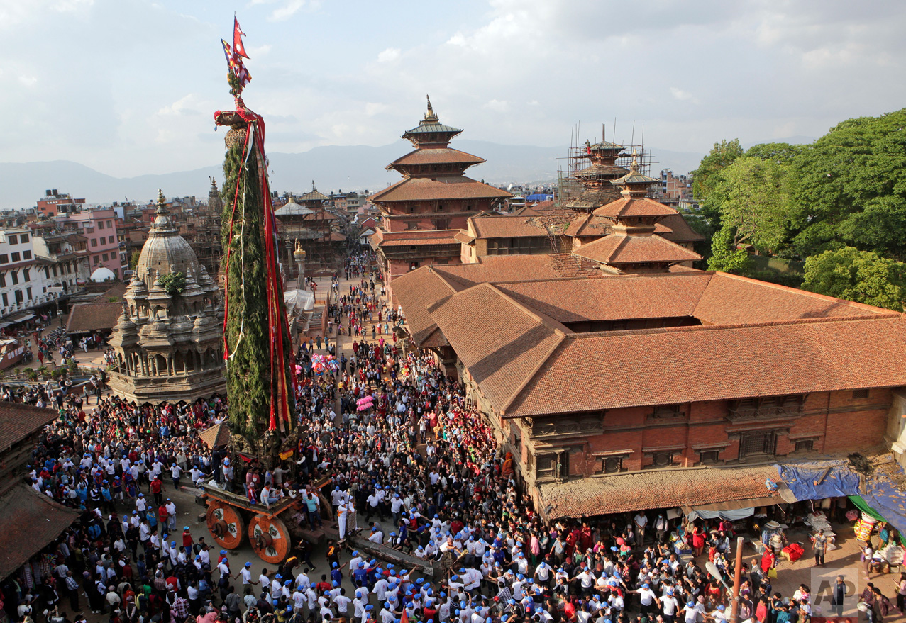  In this May 2, 2017, photo, Nepalese members of the Newar community pull the Rato Machindranath Chariot in Lalitpur, Nepal. The legend says that around the 7th century there was massive drought in the Kathmandu valley. It was believed that the arriv