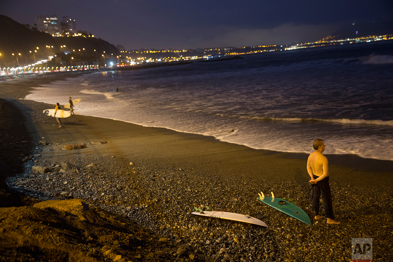  In this April 21, 2017 photo, a man looks out at the Pacific Ocean from the shore at La Pampilla beach in Lima, Peru. Pampilla is the second beach in Latin America that is set up for night surfing. (AP Photo/Rodrigo Abd) 