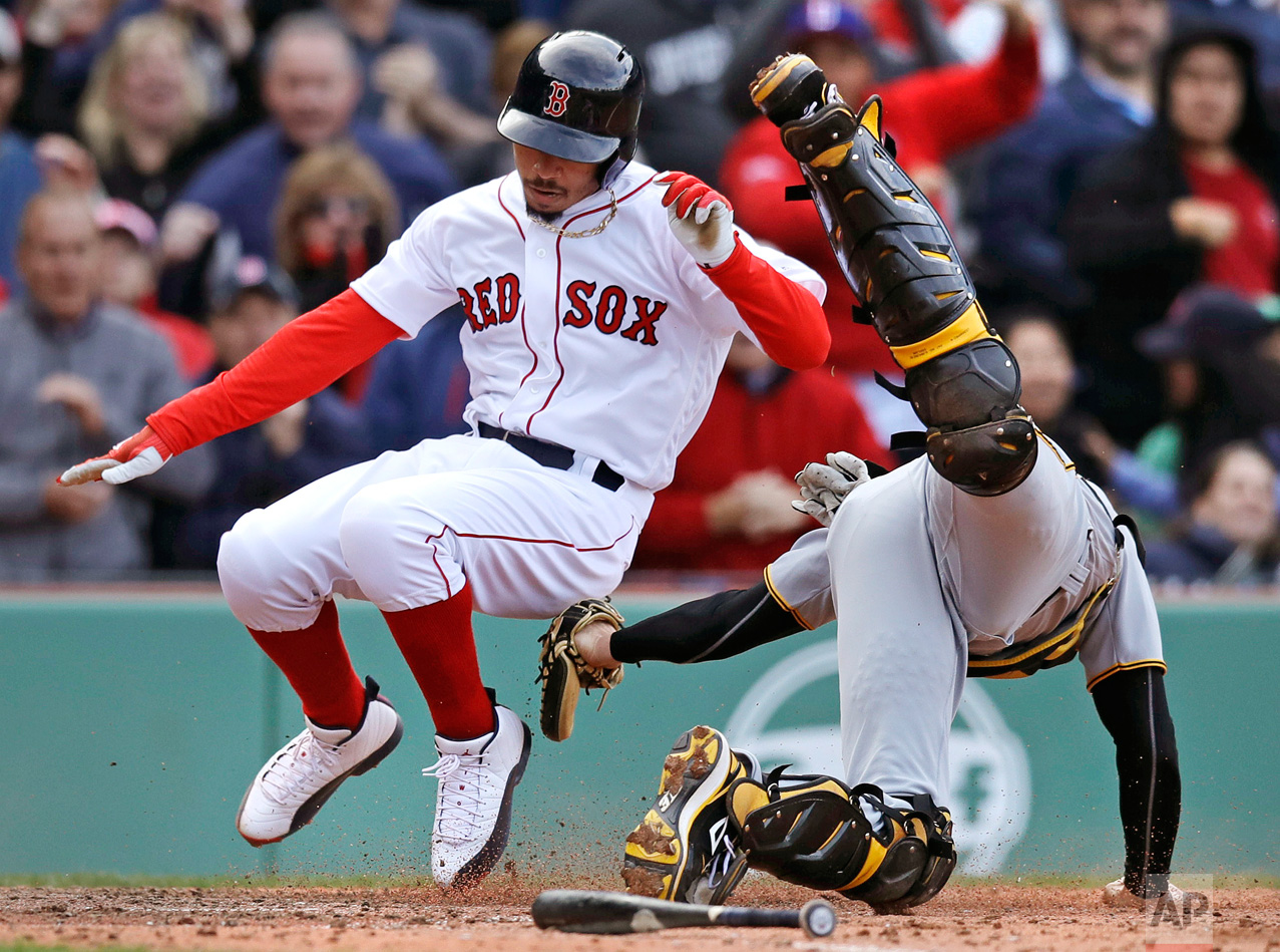  Pittsburgh Pirates catcher Chris Stewart, right, tags out Boston Red Sox's Mookie Betts while trying to score on a hit by Hanley Ramirez during the eighth inning of a baseball game at Fenway Park in Boston, Thursday, April 13, 2017. (AP Photo/Charle