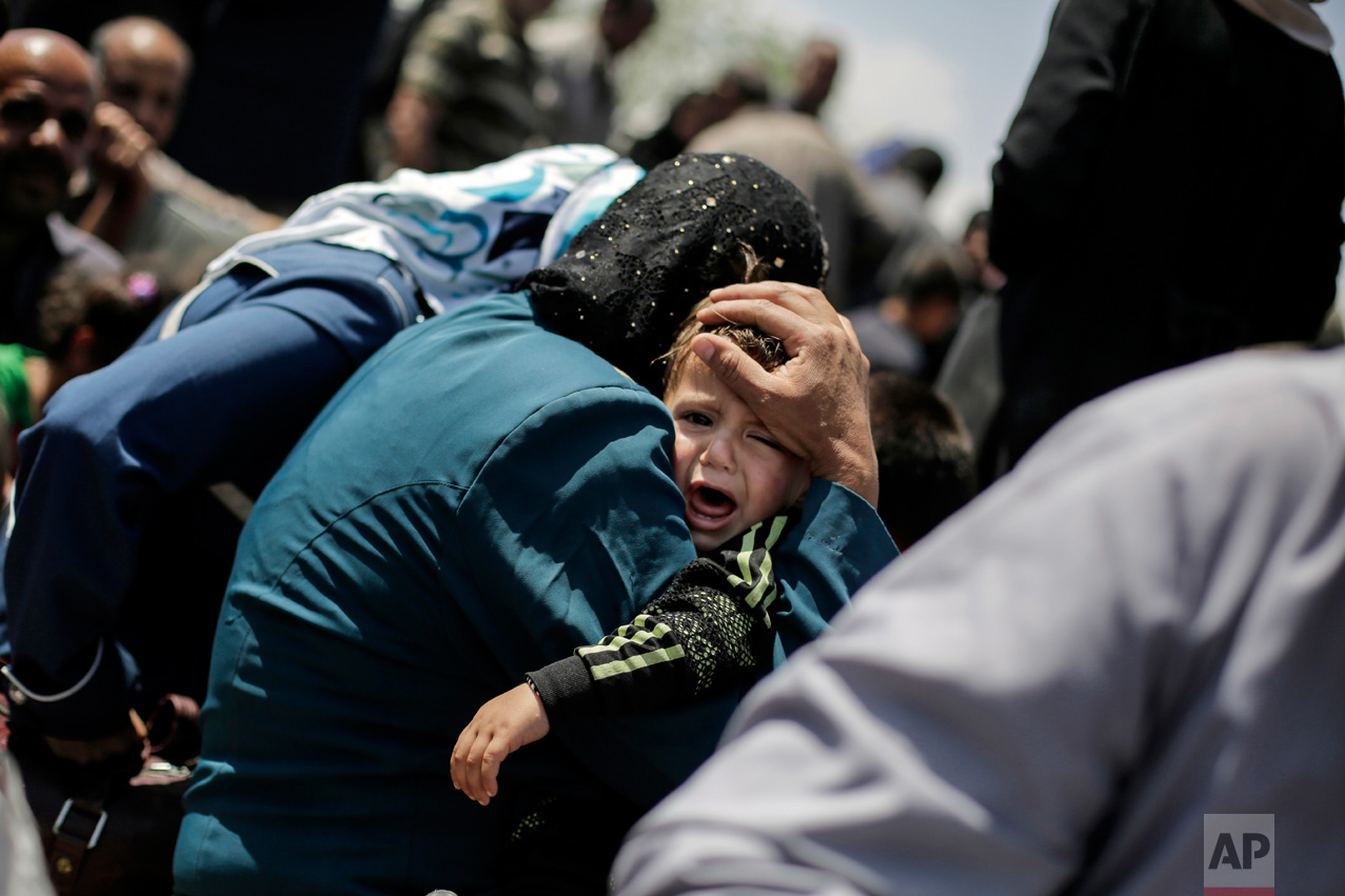  A child cries onboard a ferry to cross the Tigris River, Friday, May 5, 2017. Mosul residents are returning from the west to the liberated eastern part of the city. The government fight against Islamic State fighters for Mosul's west has been slow a