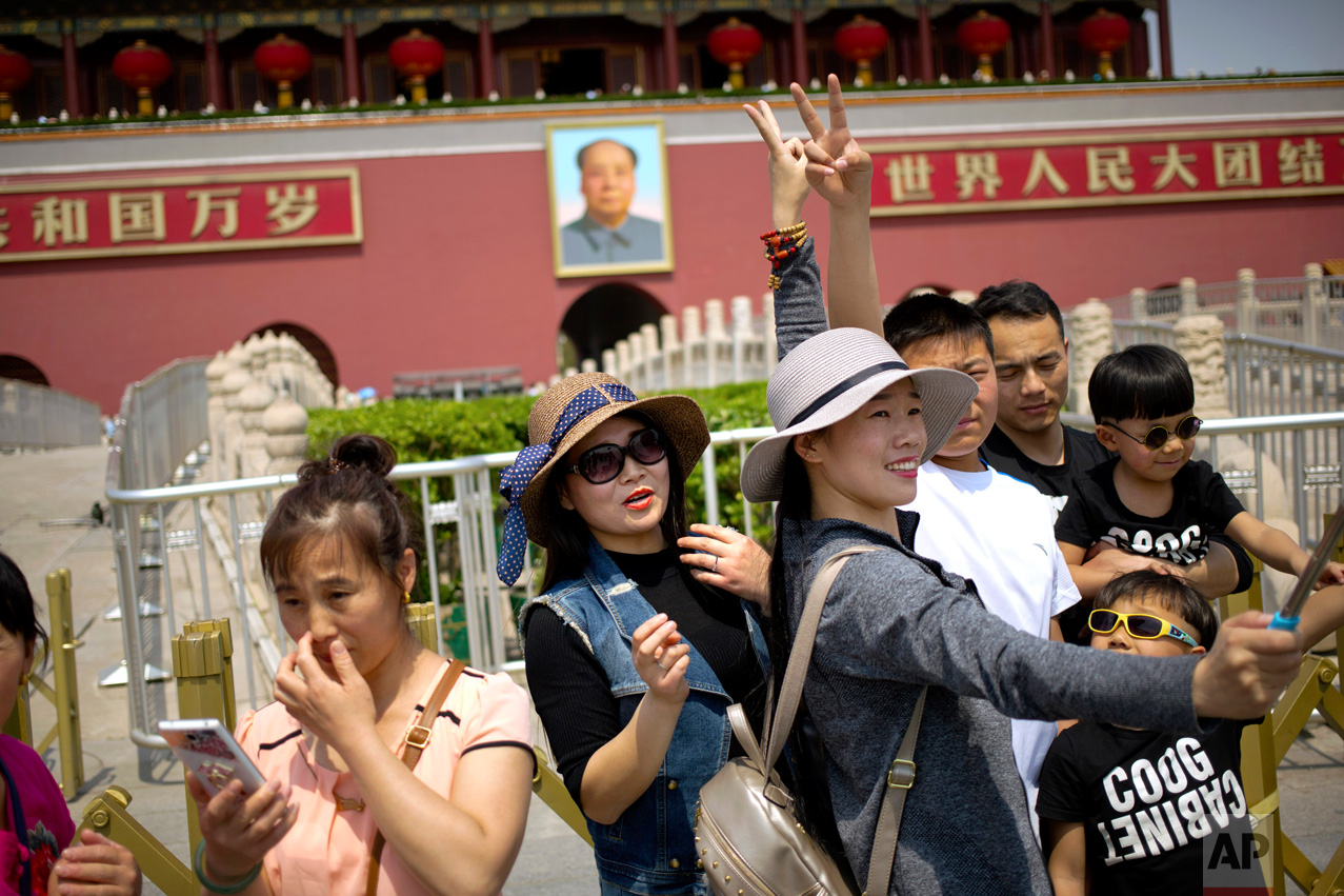  People pose for a selfie photo in front of Tiananmen Gate during the May Day holiday in Beijing, Monday, May 1, 2017. Millions are taking advantage of the holidays to visit popular tourist sites. Around the world, some workers and activists marked M