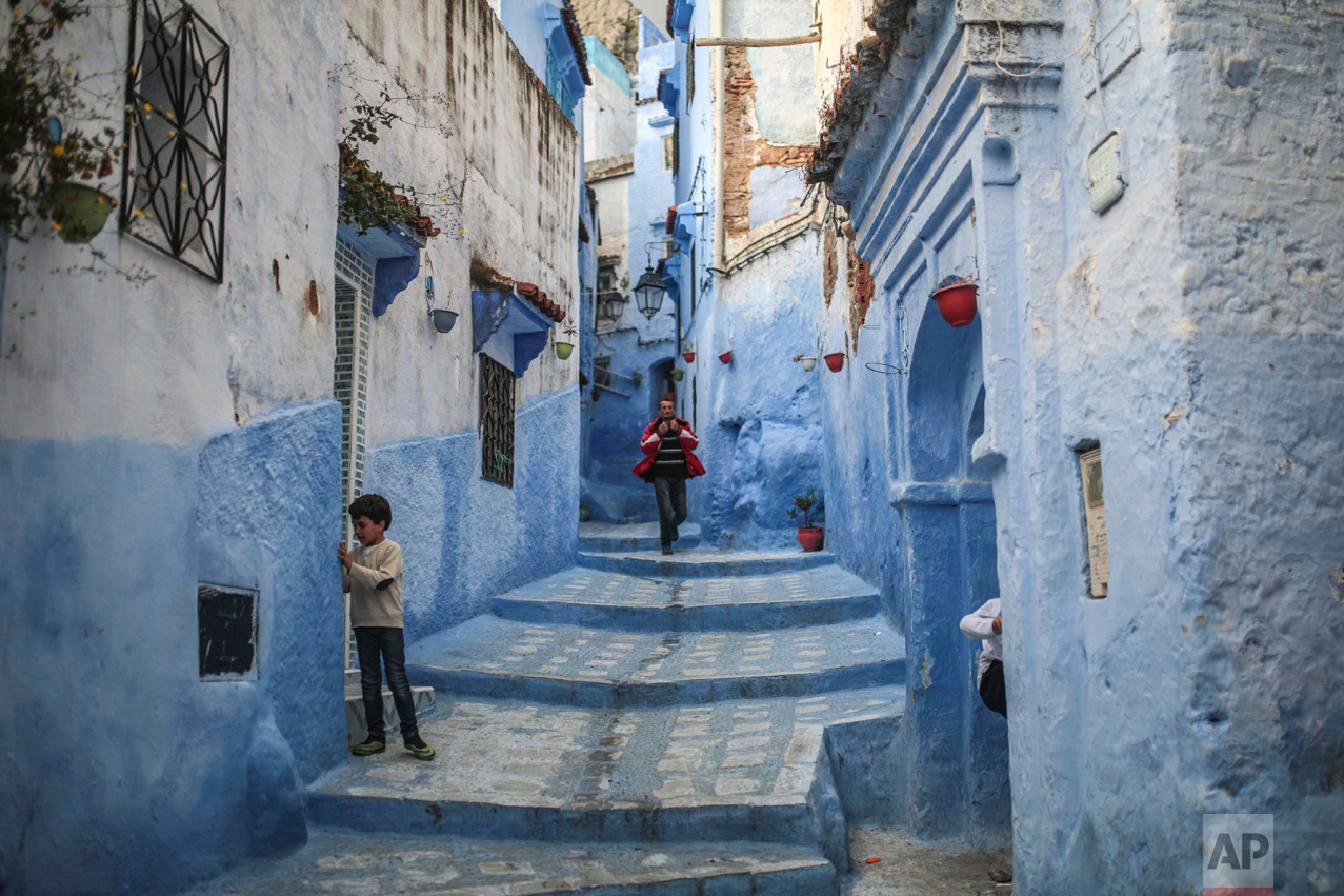  A boy plays outside his house as a man walks down the alleyway in the Medina of Chefchaouen, a town famous for its blue-painted houses and alleyways, in northern Morocco on Saturday, April 29, 2017. (AP Photo/Mosa'ab Elshamy) 