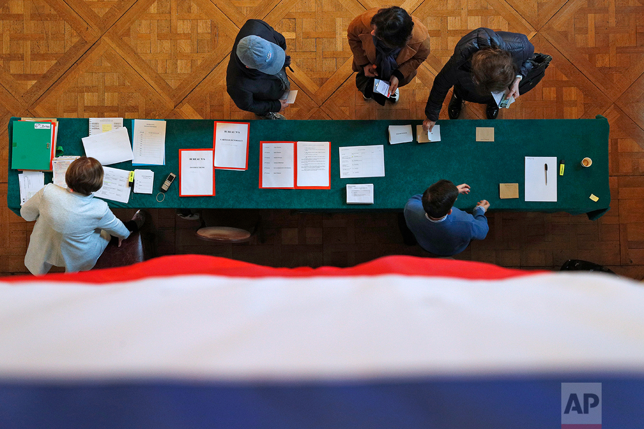  The French flag hangs from a balustrade as voters cast their ballots in the presidential runoff election between Emmanuel Macron and Marine Le Pen, in Le Touquet, France, Sunday, May 7, 2017.  (AP Photo/Christophe Ena) 