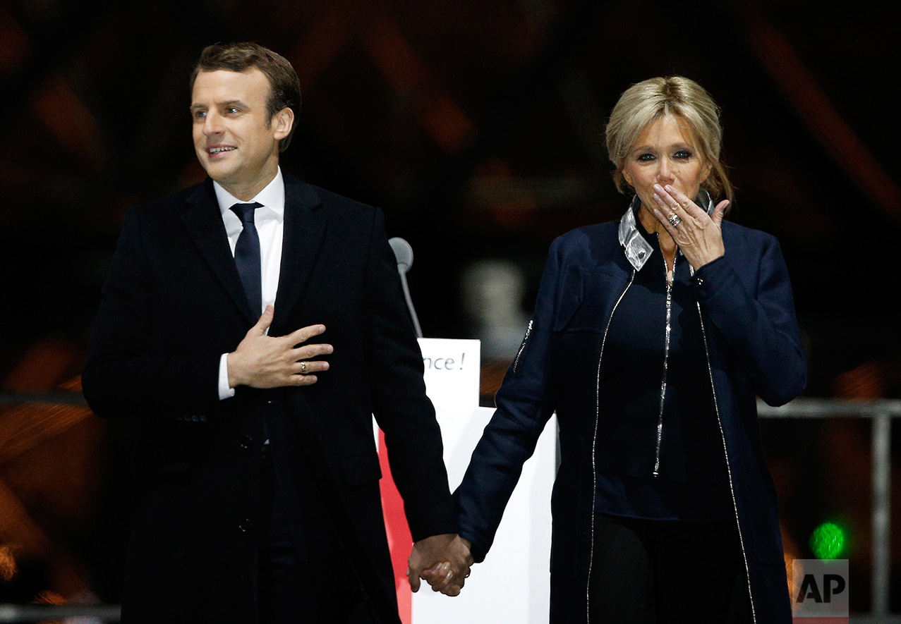  French President-elect Emmanuel Macron holds hands with his wife Brigitte during a victory celebration outside the Louvre museum in Paris, France, Sunday, May 7, 2017. (AP Photo/Thibault Camus) 