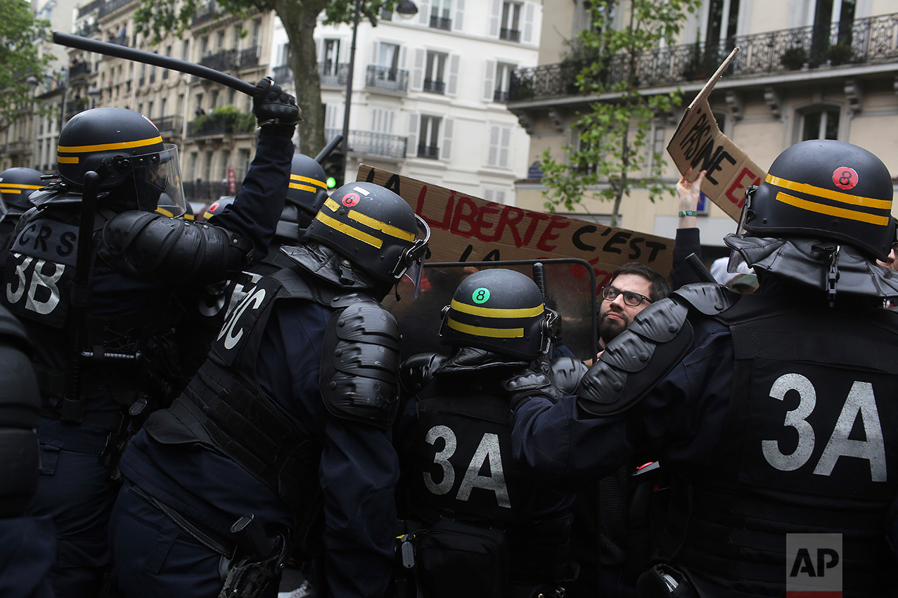  Clashes between riot police officers and protestors during a demonstration called by labour unions the day after the French presidential election, Monday, May 8, 2017. Placard in the center reads "Freedom".  Former civil servant and investment banke