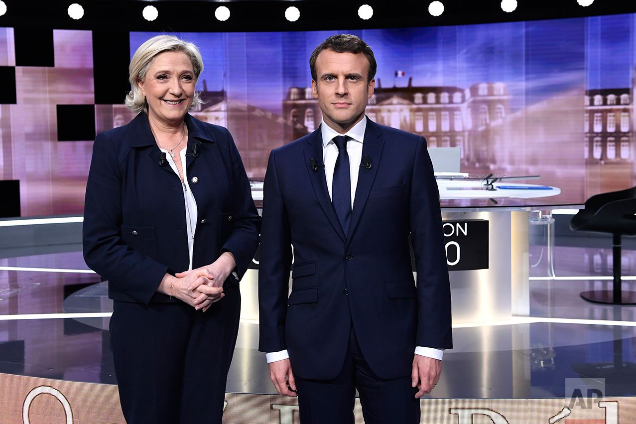  French presidential election candidate for the far-right Front National party, Marine Le Pen, 2nd left, and French presidential election candidate for the En Marche ! movement, Emmanuel Macron, right, pose prior to the start of a live broadcast face