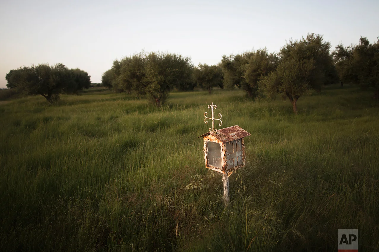  In this photo taken on Friday, April 28, 2017, an iron shrine stands near the road in a field of olive trees in the village of Efyra, in the Peloponnese region of southern Greece. (AP Photo/Petros Giannakouris) 