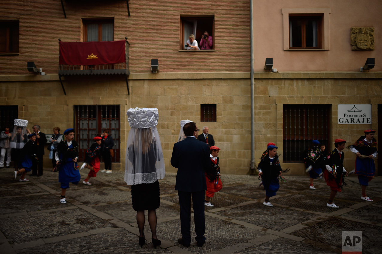 Participants of ''Prioresses Procession'', take part in the ceremony in honor of Domingo de La Calzada Saint (1019-1109), who helped poor people and pilgrims, in Santo Domingo de La Calzada, northern Spain, on Wednesday, May 10, 2017. Every year during the spring, ''Las Prioras'' (Prioresses) don a basket covered with white cloth and dress in black while they walk through the old village in honor of the saint. (AP Photo/Alvaro Barrientos)
