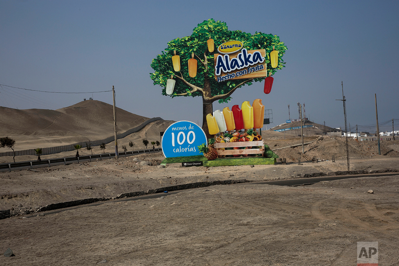  In this May 5, 2017 photo, a billboard advertising popsicles stands along the Pan American Highway on the south side of Lima, Peru, Friday, May 5, 2017. In the coastal regions, home to the capital Lima and most of the country's industry, the 2014 po