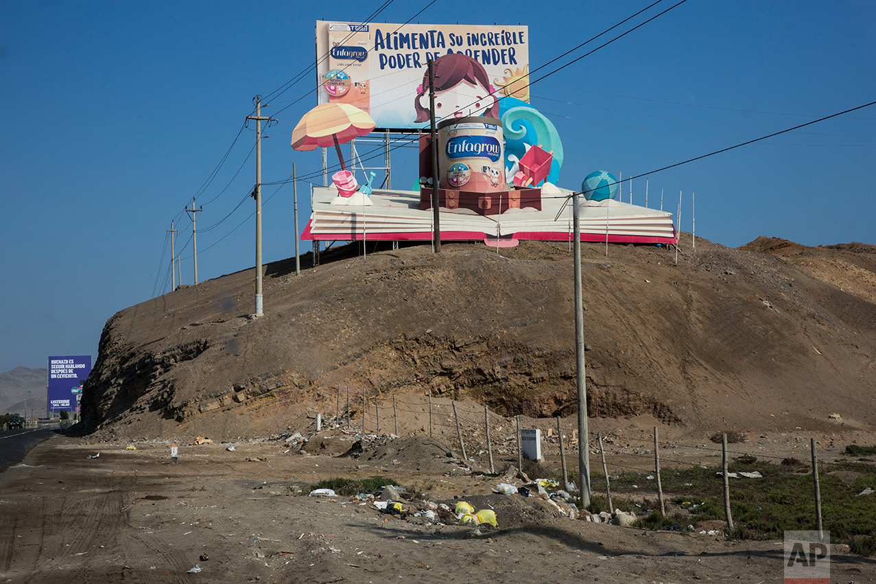  In this May 5, 2017 photo, a giant billboard advertising powdered milk reads in Spanish "Feed your incredible power to learn" as it stands on a hill along the Pan American Highway on the south side of Lima, Peru. As the cars zoom by on their way to 