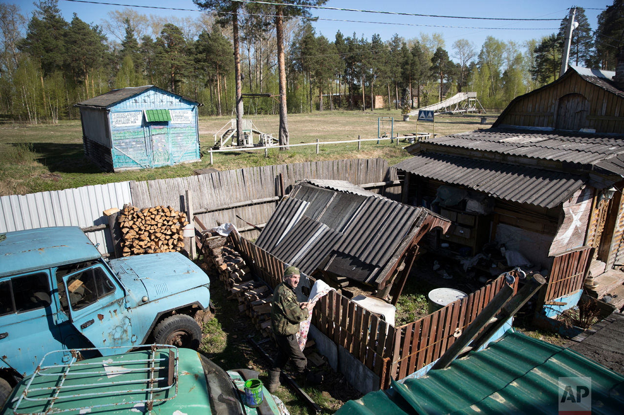  In this photo taken on Wednesday, May 3, 2017, Mikhail Korhunov stands in a yard of his house in the village of Severnaya Griva, about 130 kilometers (80 miles) east of Moscow, Russia. In this sparsely populated village east of Moscow, Mikhail Korsh