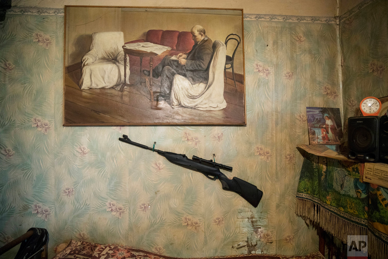  In this photo taken on Wednesday, May 3, 2017, a hunting rifle and a portrait of Soviet founder Vladimir Lenin are placed on a wall of Korhunov's house in the village of Severnaya Griva, about 130 kilometers (80 miles) east of Moscow, Russia.&nbsp;(
