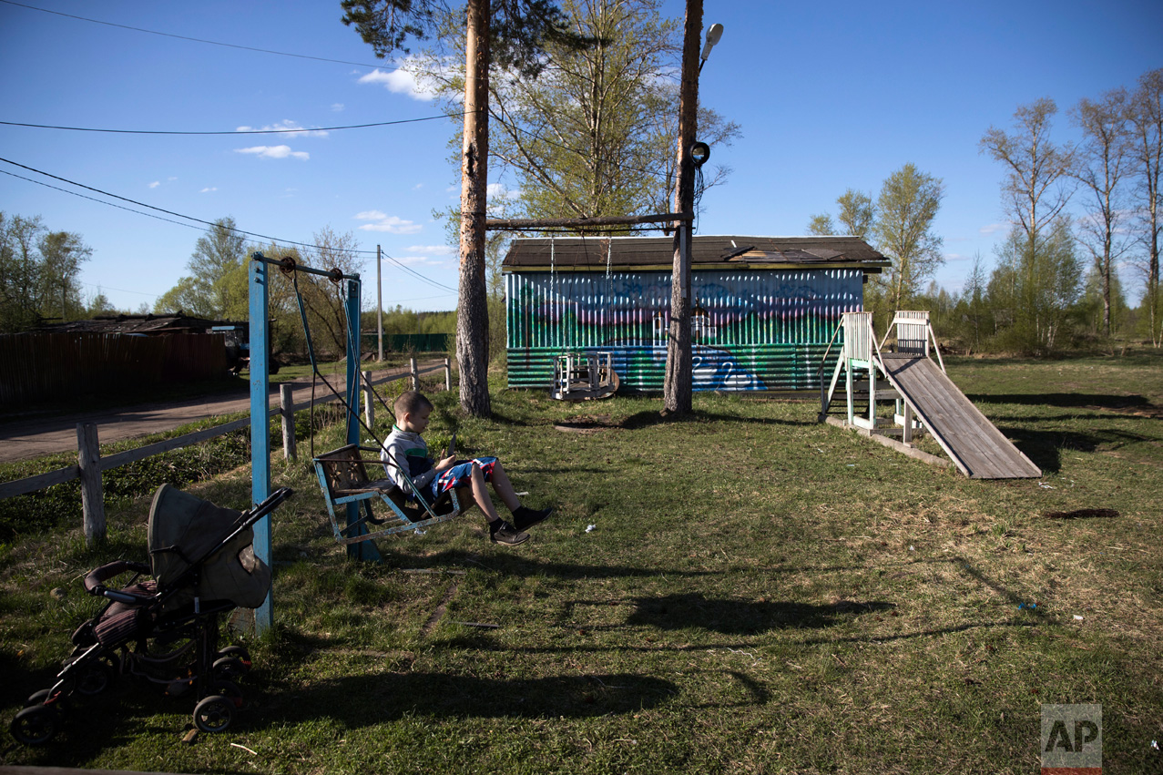  In this photo taken on Wednesday, May 3, 2017, a boy plays on a swing in the village of Severnaya Griva, about 130 kilometers (80 miles) east of Moscow, Russia. The swings and a wooden slope were built by Mikhail Korhunov. (AP Photo/Pavel Golovkin) 