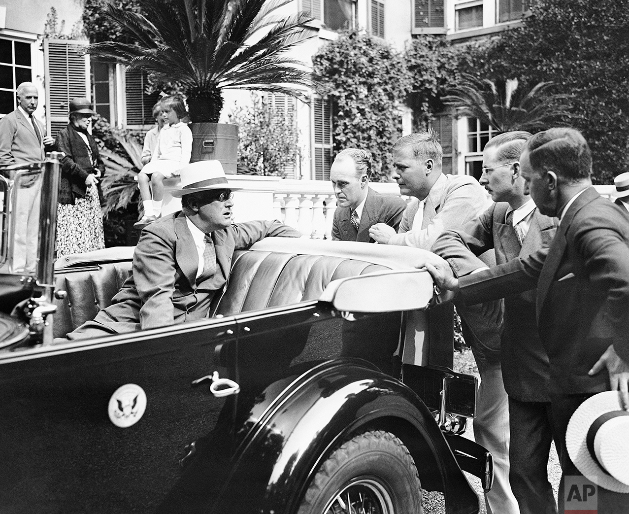  President Franklin D. Roosevelt speaks to reporters on his arrival at Hyde Park, N.Y., Aug. 20, 1933, to resume his vacation.  (AP Photo) 