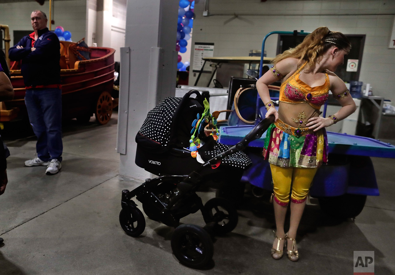  Ringling Bros. high wire performer Anna Lebedeva stands next to her 3-month-old son, Amir, in his stroller while waiting to go on for the show's finale, Friday, May 5, 2017, in Providence, R.I. Lebedeva and her husband, fellow performer Mustafa Dang