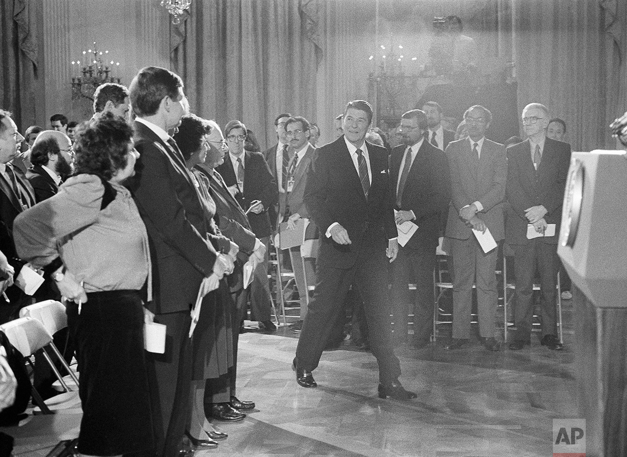  President Ronald Reagan enters the White House East Room in Washington, Feb. 22, 1984 for a news conference, his first formal session with reporters since Dec. 20.  Reagan labeled as "disgraceful, frankly," speculation that Secretary of State George