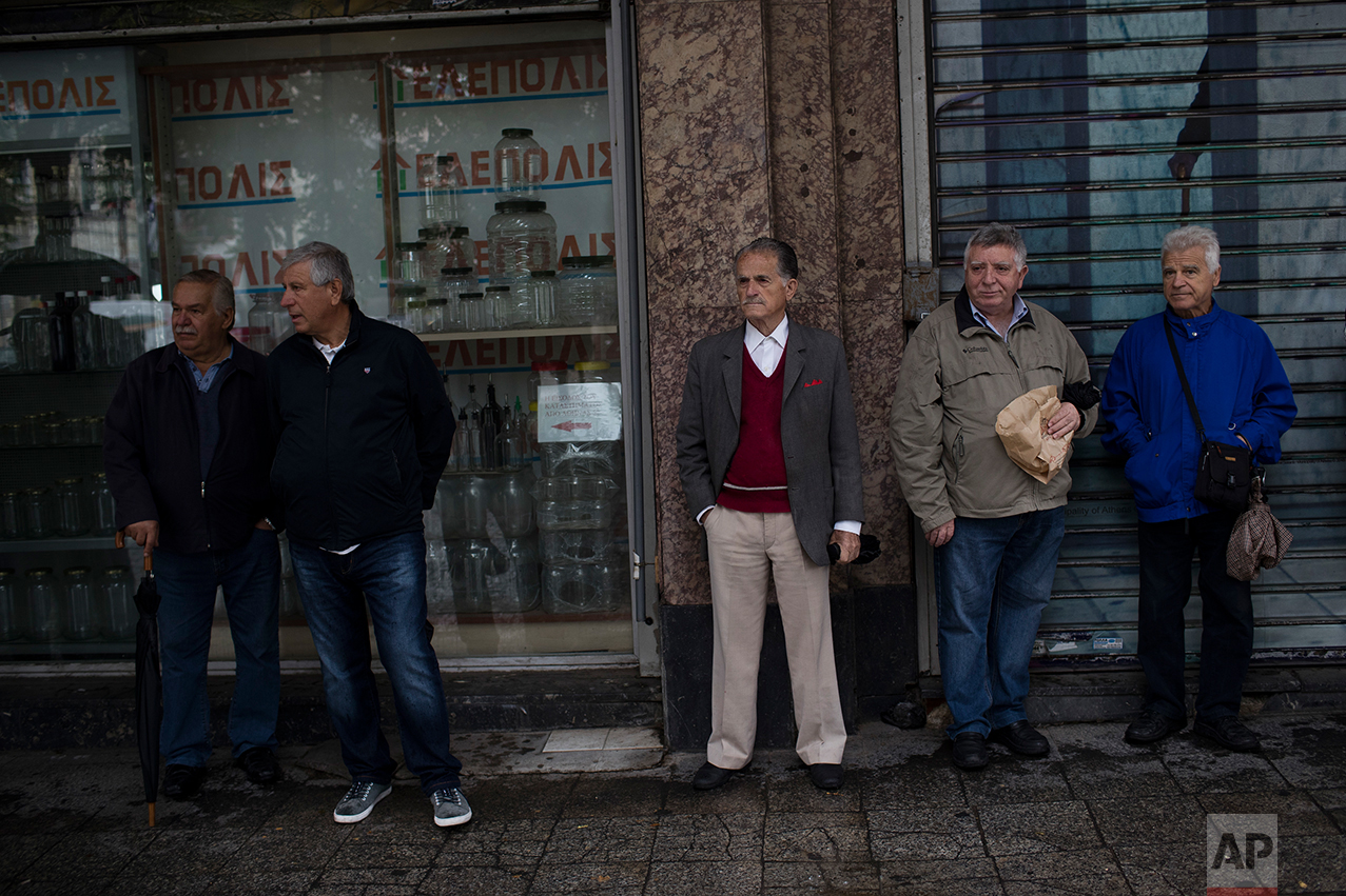  In this Thursday, May 18, 2017 photo, Greek pensioners stand with other retirees as they gather to take part in an anti-austerity rally in central Athens. (AP Photo/Petros Giannakouris) 