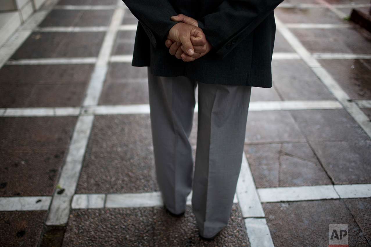  In this Thursday, May 18, 2017 photo an elderly man walks during a rainfall in central Athens. &nbsp;(AP Photo/Petros Giannakouris) 