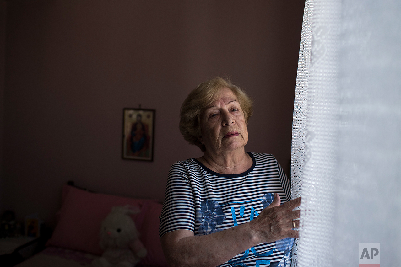  In this Monday, May 15, 2017 photo, Greek pensioner Mina Griva, 78, a widow and former factory worker in Germany, poses in her home in Athens. &nbsp;(AP Photo/Petros Giannakouris) 