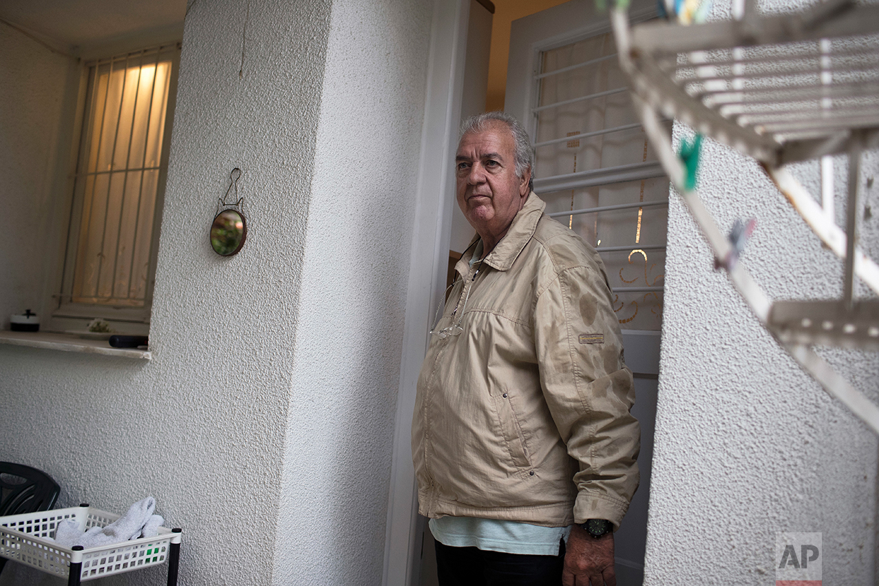  In this Wednesday, May 17, 2017 photo, Greek pensioner Paraksevas Kokkinakis, 71, a former private bank manager, poses outside his house in Athens. Kokkinakis had never expected to face financial difficulties later in life , he said, "It never cross